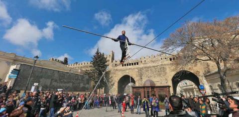 Acrobat walks on rope